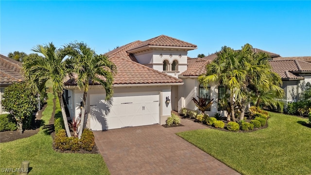 mediterranean / spanish-style house with a front yard and a garage