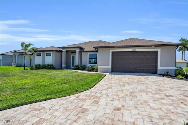 view of front of property featuring a garage and a front yard