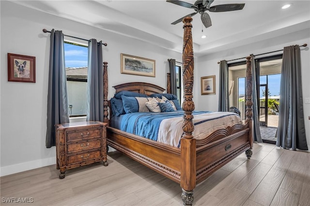 bedroom featuring ceiling fan, light hardwood / wood-style flooring, access to outside, and multiple windows