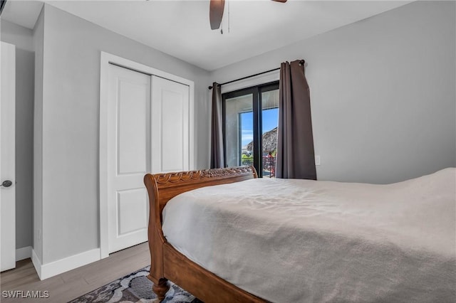 bedroom with ceiling fan, a closet, and hardwood / wood-style floors