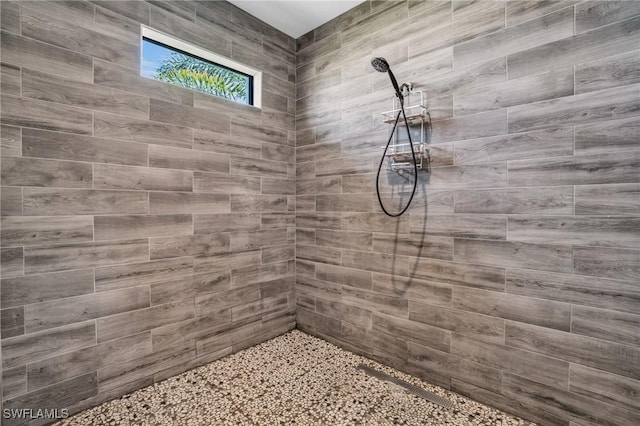 bathroom with tiled shower