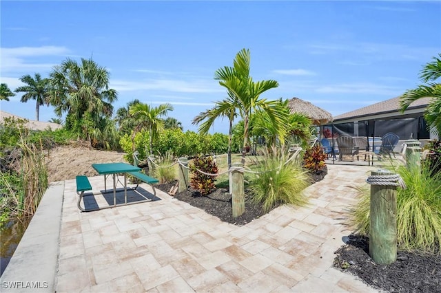 view of patio / terrace featuring glass enclosure