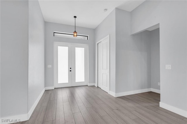 entrance foyer with light wood-type flooring and french doors