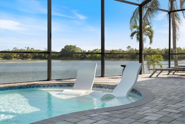 view of swimming pool with a patio, a water view, and a lanai