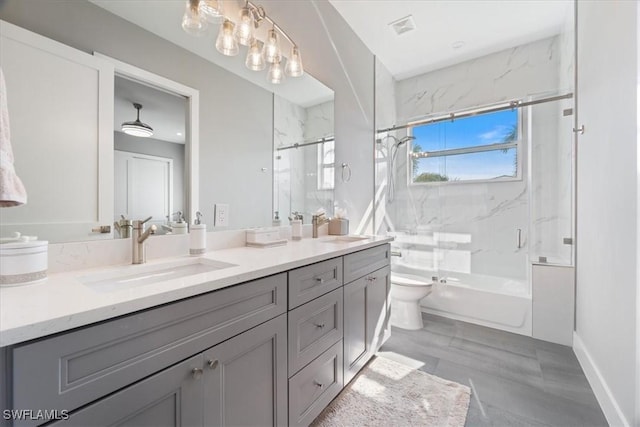 full bathroom featuring toilet, vanity, and combined bath / shower with glass door