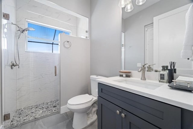 bathroom featuring toilet, vanity, and walk in shower