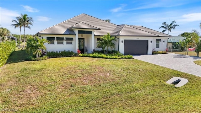 view of front facade with a front yard and a garage