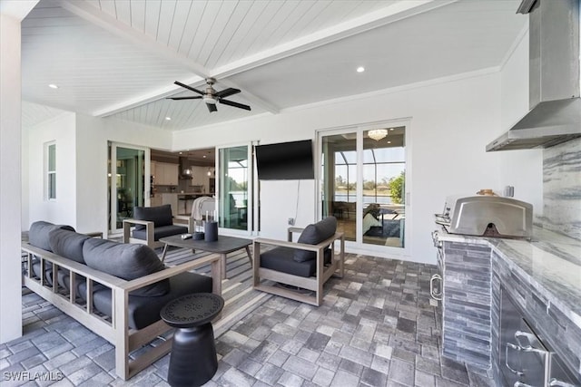 view of patio featuring an outdoor kitchen, ceiling fan, and an outdoor hangout area