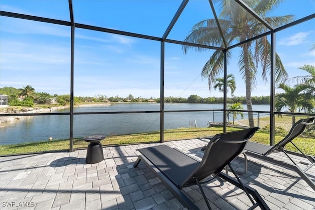 unfurnished sunroom featuring a water view