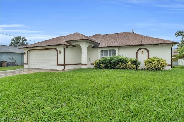 view of front of property featuring a garage and a front lawn