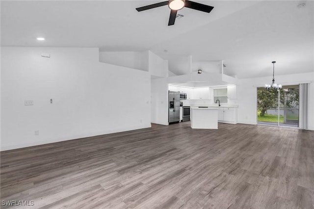 unfurnished living room with sink, ceiling fan with notable chandelier, dark hardwood / wood-style floors, and high vaulted ceiling