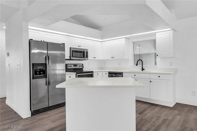 kitchen with stainless steel appliances, light hardwood / wood-style floors, a kitchen island, sink, and white cabinetry