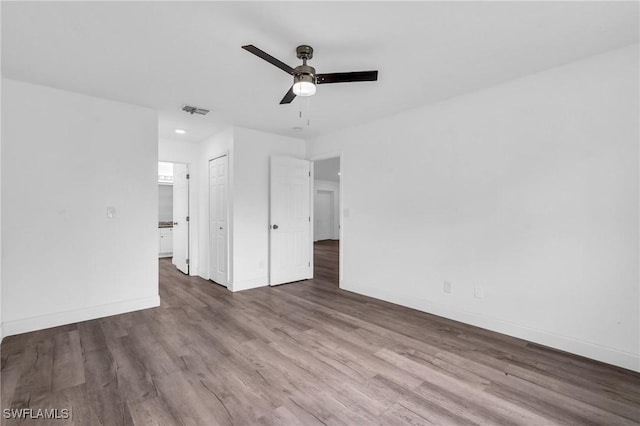 unfurnished bedroom with hardwood / wood-style flooring, ceiling fan, and a closet