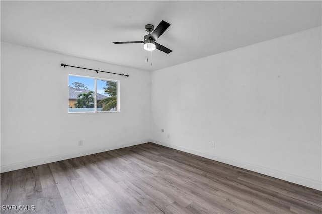 empty room with hardwood / wood-style flooring and ceiling fan