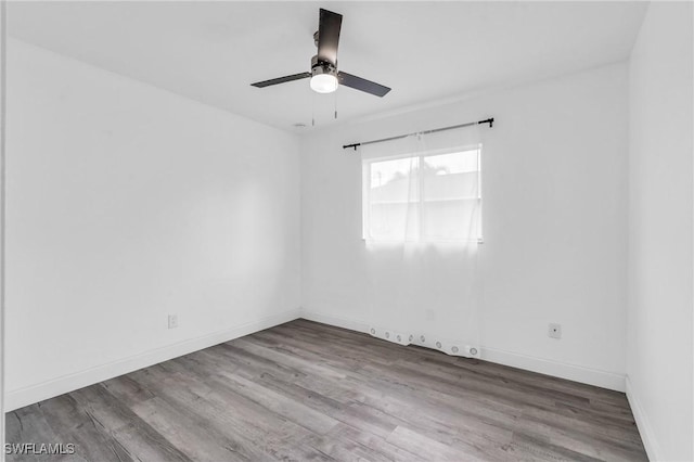 empty room with hardwood / wood-style flooring and ceiling fan