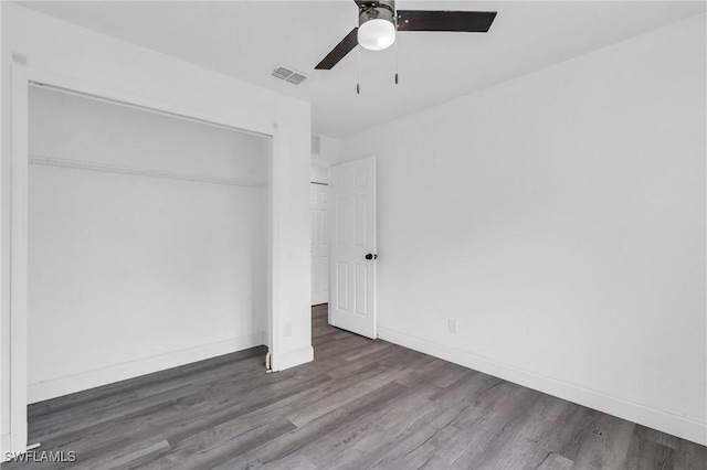 unfurnished bedroom with hardwood / wood-style floors, a closet, and ceiling fan