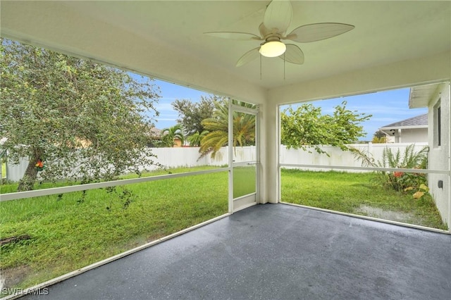 unfurnished sunroom featuring ceiling fan