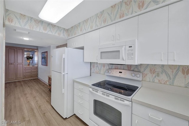 990 Cape Marco Dr Unit 1102, Marco Island, FL 34145 - kitchen with white appliances, light countertops, light wood-type flooring, white cabinetry, and tasteful backsplash
