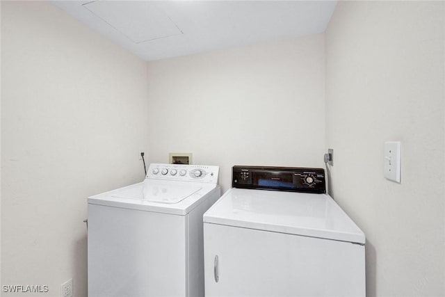 clothes washing area featuring washing machine and dryer