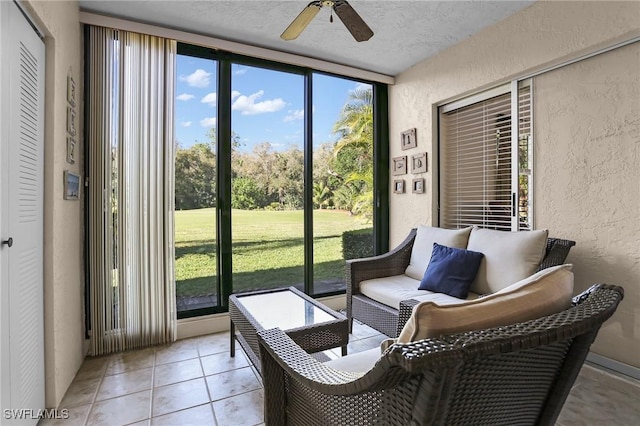 sunroom featuring ceiling fan