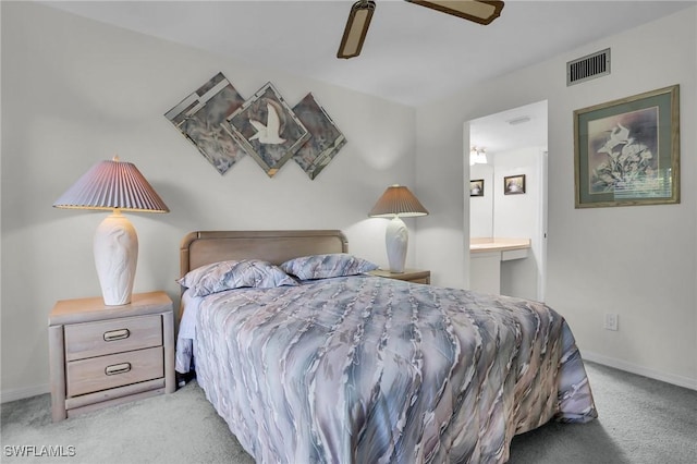 bedroom featuring light carpet, connected bathroom, and ceiling fan