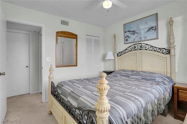 bedroom featuring ceiling fan, a closet, and light colored carpet