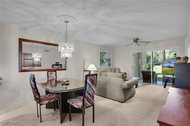 carpeted dining space with ceiling fan with notable chandelier