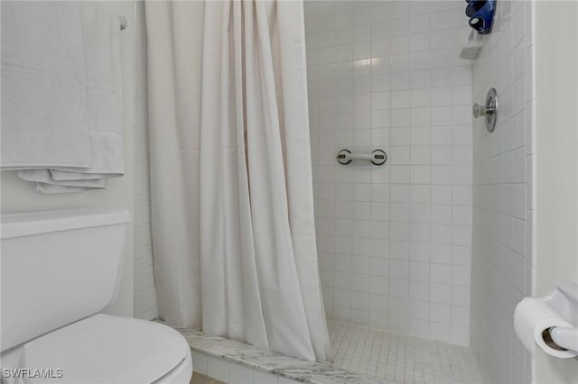 bathroom with toilet and walk in shower