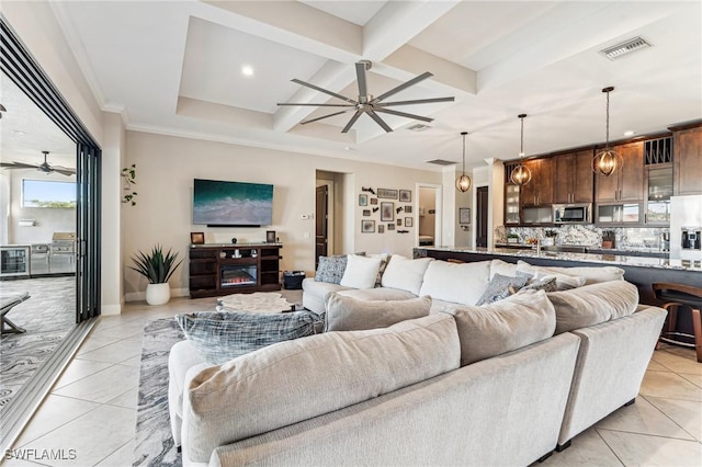 living room with coffered ceiling, beverage cooler, light tile patterned floors, beam ceiling, and a fireplace