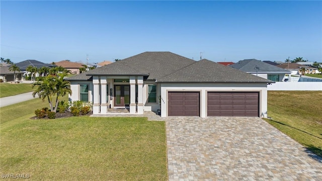 view of front of house with a garage and a front yard