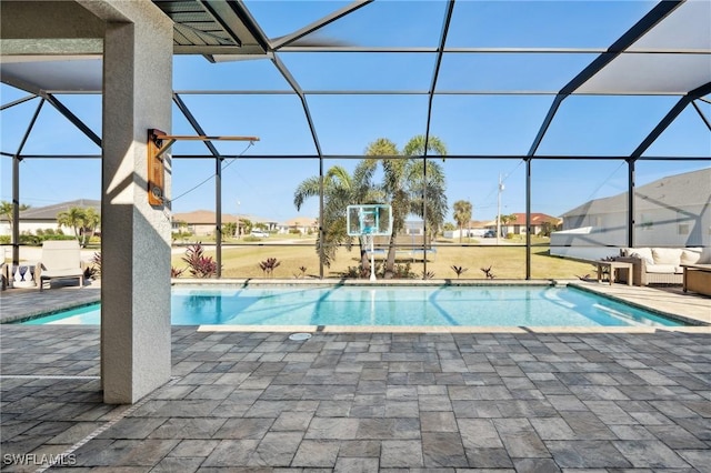 view of swimming pool with a patio and a lanai