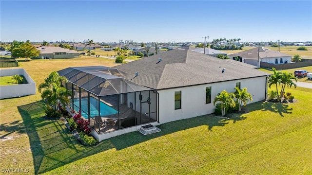 exterior space with a yard and glass enclosure