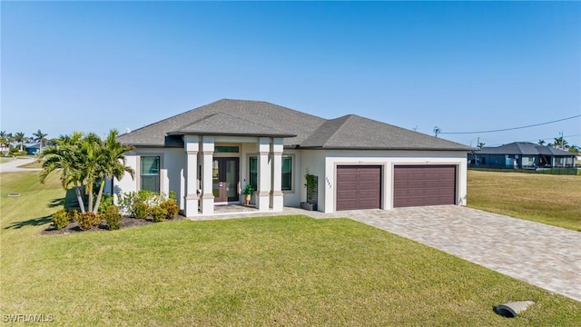 prairie-style home with a garage and a front lawn