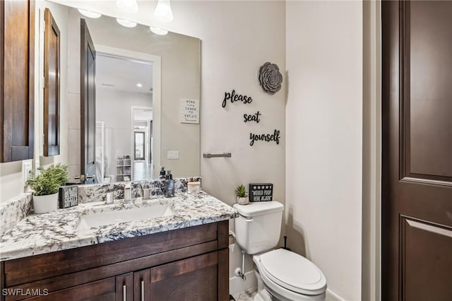 bathroom featuring vanity and toilet