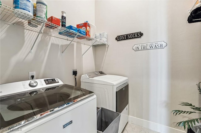 laundry area with independent washer and dryer