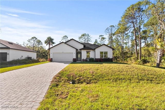 view of front of house with a front lawn and a garage