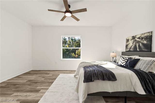 bedroom with hardwood / wood-style flooring and ceiling fan