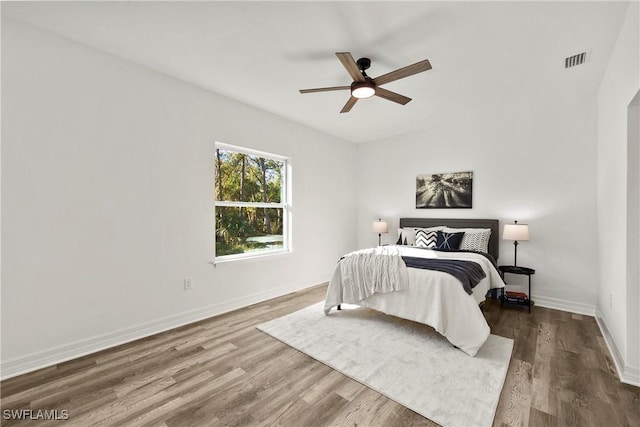 bedroom with hardwood / wood-style floors and ceiling fan