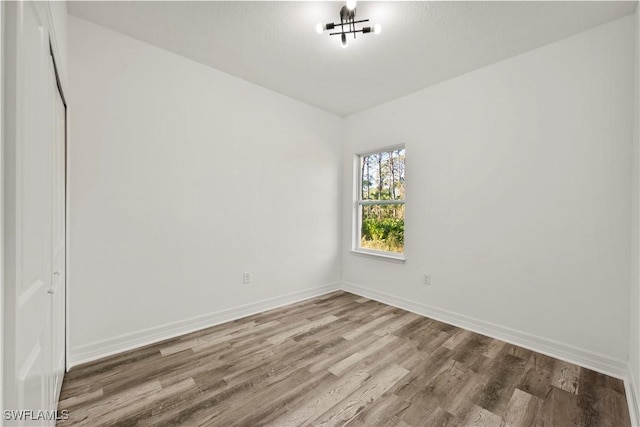 empty room with hardwood / wood-style floors