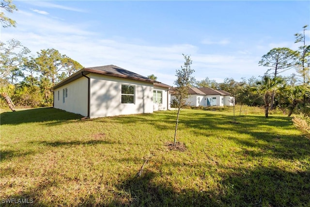 rear view of property with a lawn