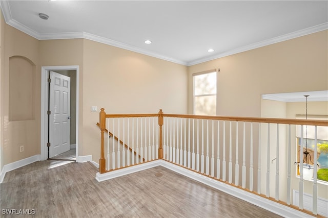 unfurnished room featuring hardwood / wood-style floors and ornamental molding