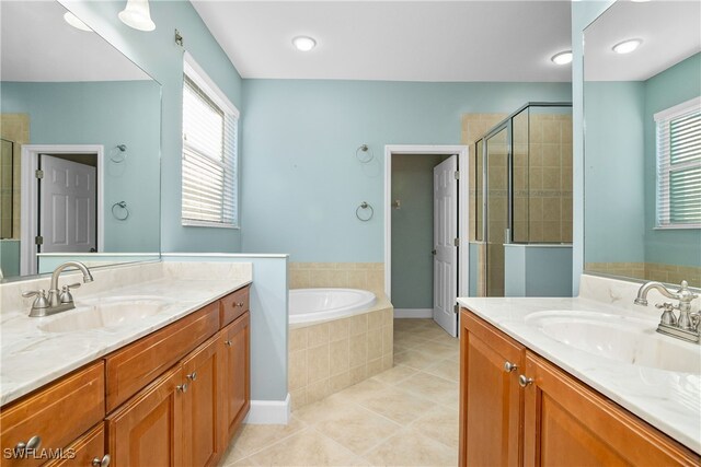 bathroom with tile patterned floors, vanity, and plus walk in shower