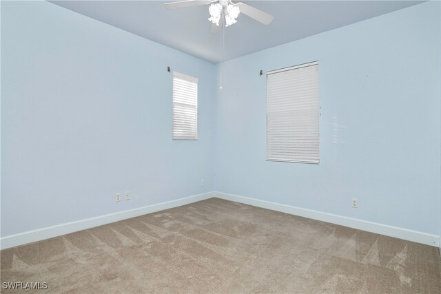 empty room with ceiling fan and light colored carpet