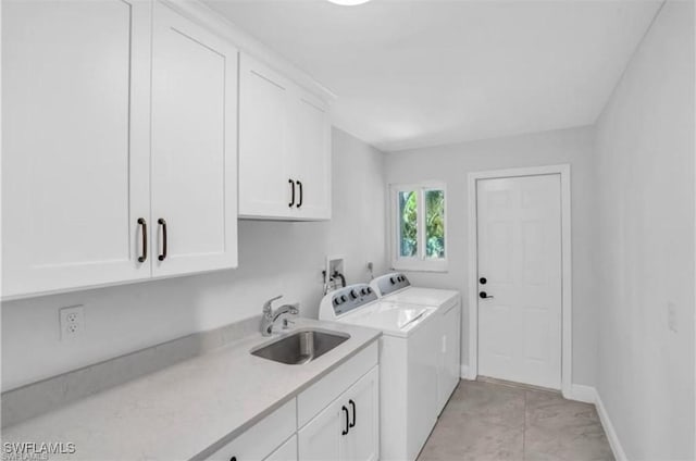 laundry room featuring sink, cabinets, and independent washer and dryer