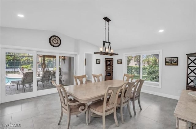 dining area with tile patterned floors and vaulted ceiling