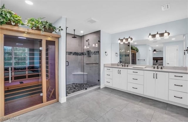 bathroom with vanity, ceiling fan, and an enclosed shower