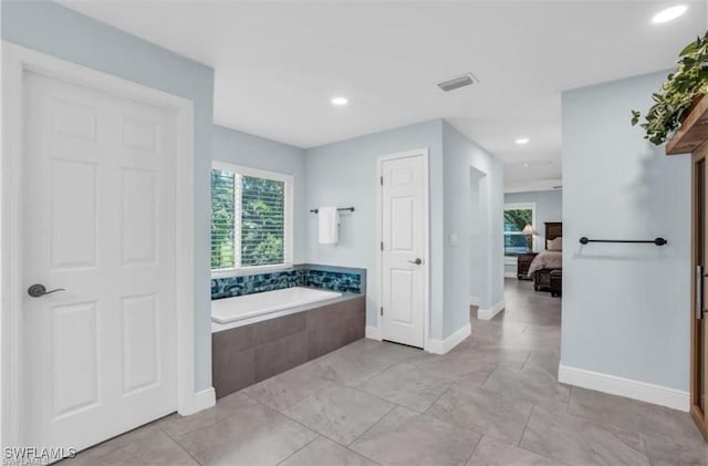 bathroom featuring tiled tub