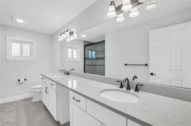 bathroom featuring tile patterned flooring, vanity, toilet, and an enclosed shower