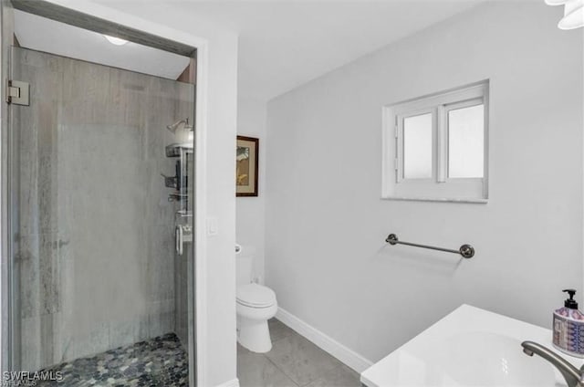 bathroom featuring vanity, toilet, and a shower with door