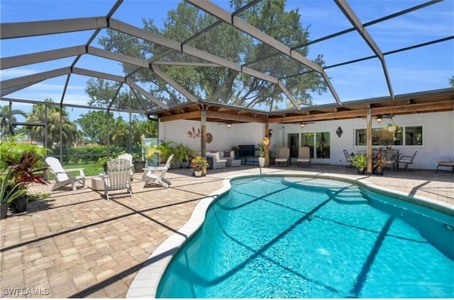 view of pool with an outdoor hangout area, a patio area, ceiling fan, and a lanai